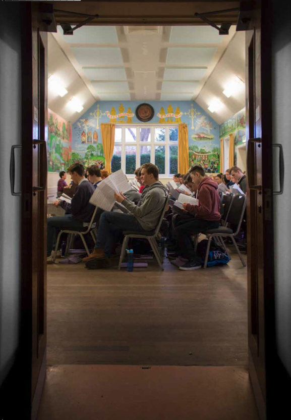 Taplow Youth Choir members in rehearsal, seen through an open doorway at the Village Hall.